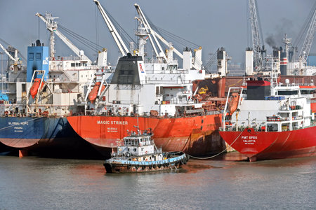 Haldia, India, October, 27, 2020. Seagoing vessels, tugboats at the port under cargo operations and underway.のeditorial素材