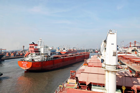 Haldia, India, October, 27, 2020. Seagoing vessels, tugboats at the port under cargo operations and underway.のeditorial素材
