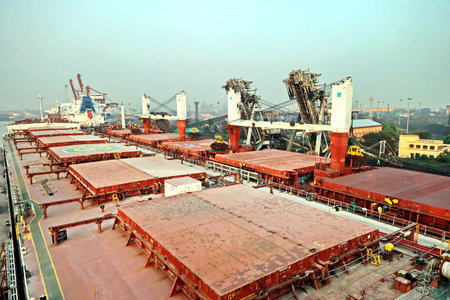 Haldia, India, October, 27, 2020. Cargo terminal for unloading bulk cargo of limestone by shore cranes and grabs. Views of cargo equipment for discharging of bulk cargoes.のeditorial素材