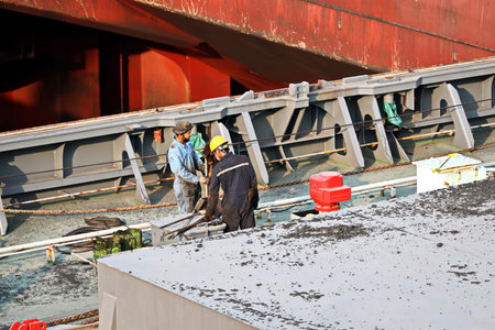 Haldia, India, October, 27, 2020. Cargo terminal for unloading bulk cargo of limestone by shore cranes and grabs. Views of cargo equipment for discharging of bulk cargoes.のeditorial素材