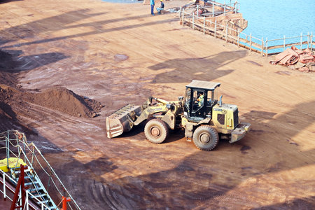 Gopalpur, India, November, 03-05, 2020. Cargo terminal for loading bulk cargo of iron ore by ship cranes and grabs. Views of cargo equipment for discharging of bulk cargoes.のeditorial素材