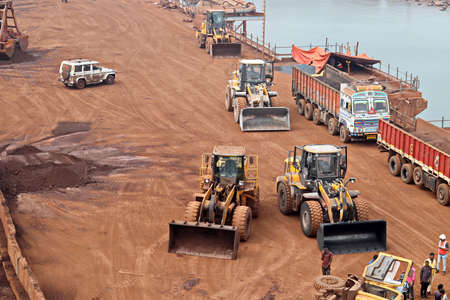 Gopalpur, India, November, 03-05, 2020. Cargo terminal for loading bulk cargo of iron ore by ship cranes and grabs. Views of cargo equipment for discharging of bulk cargoes.のeditorial素材