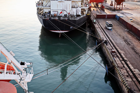 Seagoing vessels, tugboats at the port under cargo operations and underway in the port of Huludao,...