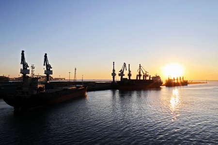 Various sunset views of the docks, piers, terminal of the Port of Huludao, China.の写真素材