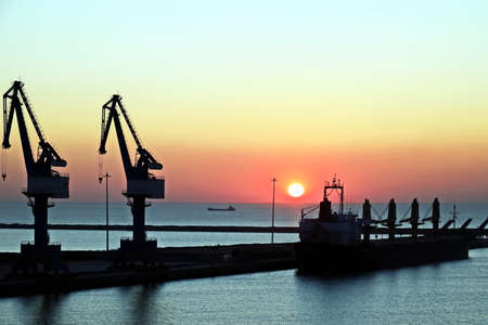 Various sunset views of the docks, piers, terminal of the Port of Huludao, China.の写真素材