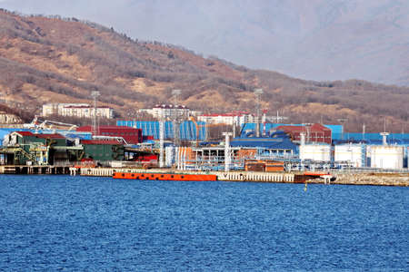 Port of Vostochnyy. Russia, December, 08, 2020. Cargo terminal for loading steel plates into bulk carrier by shore cranes.のeditorial素材
