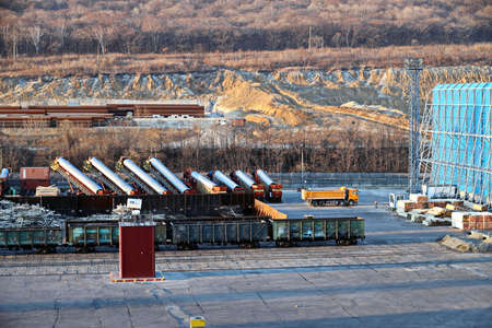 Port of Vostochnyy. Russia, December, 08, 2020. Cargo terminal for loading steel plates into bulk carrier by shore cranes. Views of the cargo equipments and steel cargoes on the pier.のeditorial素材