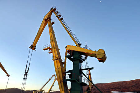 Port of Vostochnyy. Russia, December, 08, 2020. Cargo terminal for loading steel plates into bulk...