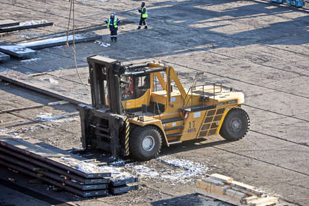 Port of Vostochnyy. Russia, December, 08, 2020. Cargo terminal for loading steel plates into bulk carrier by shore cranes. Views of the cargo equipments and steel cargoes on the pier.のeditorial素材