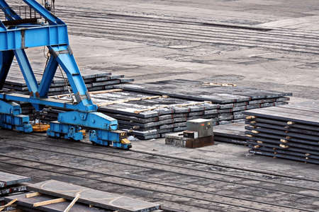 Port of Vostochnyy. Russia, December, 08, 2020. Cargo terminal for loading steel plates into bulk carrier by shore cranes. Views of the cargo equipments and steel cargoes on the pier.のeditorial素材