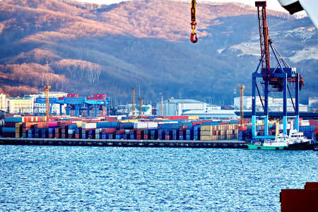 Container vessels, bulk carrier and tugboats at the port under cargo operations and underway. Port of Vostochnyy. Russia, December, 2020の写真素材