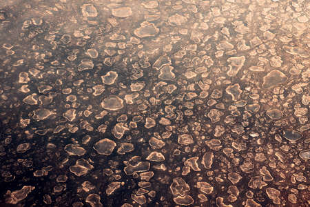 The sea water surface of the ocean with ice presence in winter weather as a background.の写真素材