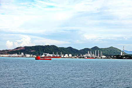 Vessels, bulk carrier and tugboats at the port under cargo operations and underway. Port of Cigading, Indonesia, December, 2020の写真素材
