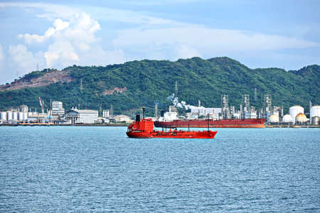 Vessels, bulk carrier and tugboats at the port under cargo operations and underway. Port of Cigading, Indonesia, December, 2020の写真素材