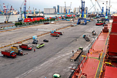 Cargo terminal for unloading steel plates from bulk carrier by ships cranes. View of the pier,...