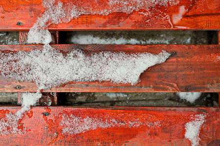 Winter and snow. Wooden boards and trunks covered with snow and ice as a base and background. Close-up.の写真素材
