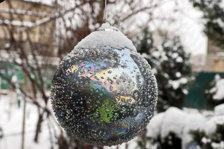 Christmas tree decorations and toys for fir trees covered with snow and ice. Close-up. Happy New Year and Merry Christmas.の写真素材