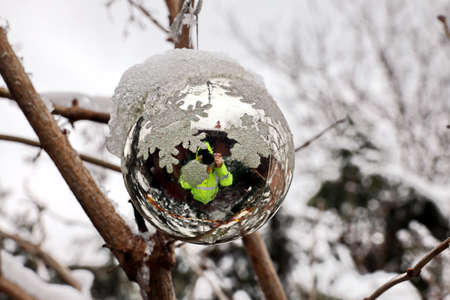 Christmas tree decorations and toys for fir trees covered with snow and ice. Close-up. Happy New Year and Merry Christmas.の写真素材