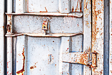 Old rusty metal door with padlock. background and texture for design.の写真素材