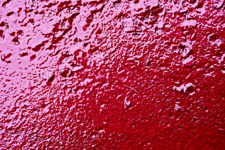 Water drops on the red wall. Abstract background and texture for design.の写真素材