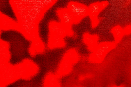 close up of red fabric texture with some spots and stains on it