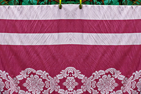 Thai style fabric pattern on clothes line in temple, Thailand.