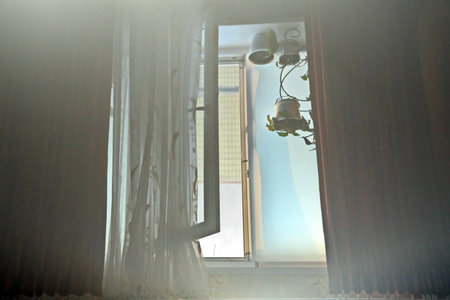Window with curtains and lights in the morning, closeup of photo