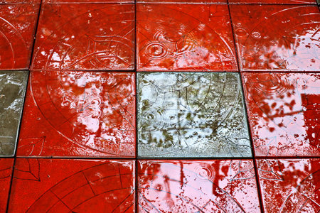 abstract background of red tiles with reflection of the sun in waterの写真素材