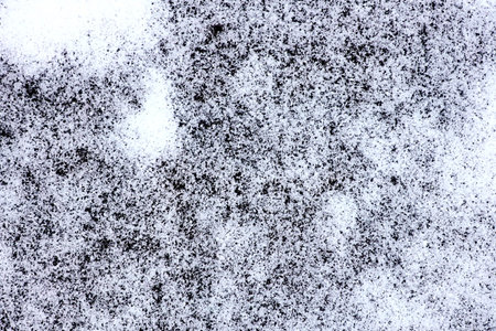 Snow on the asphalt as a background. texture. close-up.の写真素材