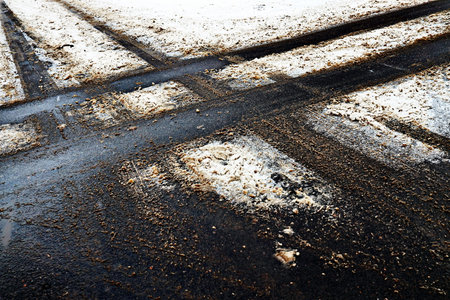 Tire tracks on the asphalt road in winter. Toned.の写真素材