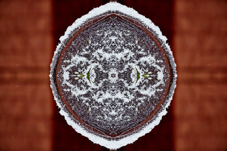 snowflake on a metal plate in front of a wooden wallの写真素材