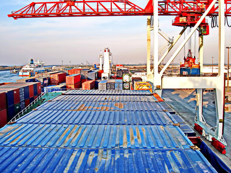 Container Cargo freight ship with working crane bridge in shipyard for Logistic Import Export...