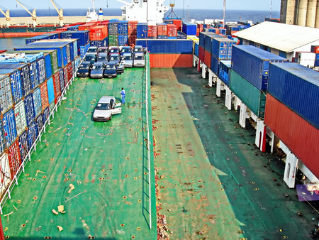Container Cargo freight ship with working crane bridge in shipyard for Logistic Import Export...