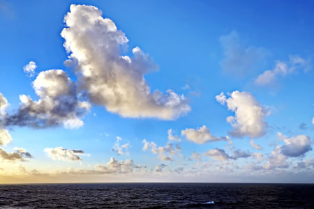 Cloudscape, Colored Clouds at Sunset near the Ocean on the Atlantic Oceanの写真素材
