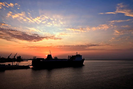 Cargo ship in the sea at sunset. Cargo transportation and shipping.の写真素材