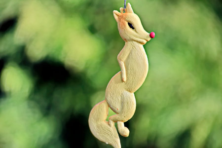 Ceramic figurine of a deer on a green background.の写真素材