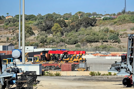 Port cargo crane, loading and unloading bulk cargo of iron ore by ship cranes and grabs