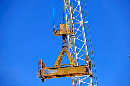 Tower crane against blue sky, close-up. industrial backgroundの写真素材