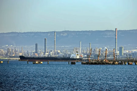Industrial landscape with oil refinery plant, sea and blue sky.の写真素材
