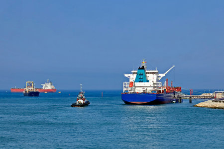 Cargo ship and tugboats in the port of Odessa, Ukraine