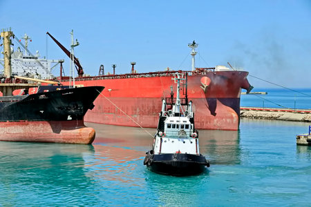 Tugboat and bulk carrier in the port of Odessa, Ukraineの写真素材