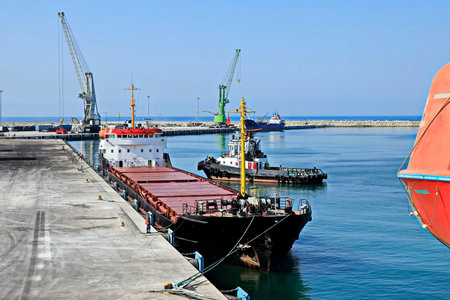 Tugboat loading bulk cargo in port, Odessa, Ukraine