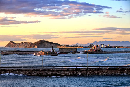 Seascape with cargo ship in the port at sunset time.の写真素材
