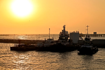 Cargo ship in the sea at sunset, closeup of photoの写真素材