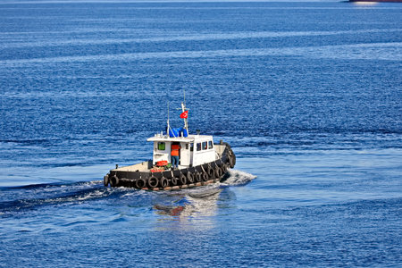 Tugboat on the background of the blue sea in the summer