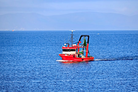 Fishing boat in the sea on a background of blue sky.の写真素材