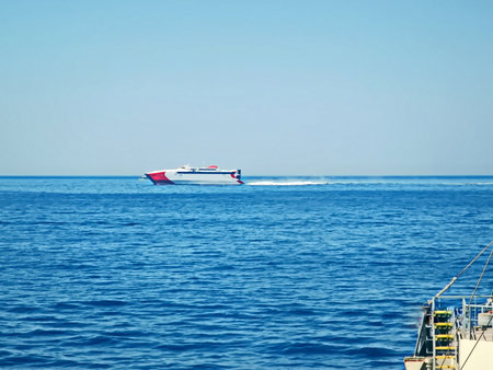 Ferry boat in the sea on a background of blue sky.の写真素材