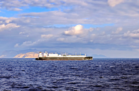 Large bulk carrier on the background of the sea and cloudy sky.の写真素材