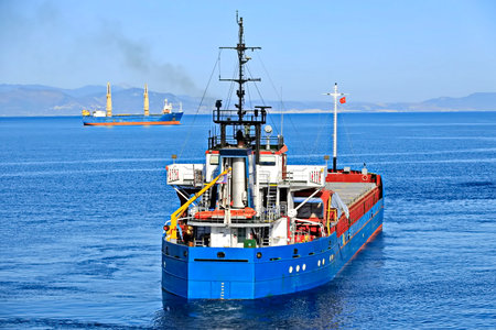 Tugboat assisting bulk cargo ship to harbor quayside, Norwayの写真素材