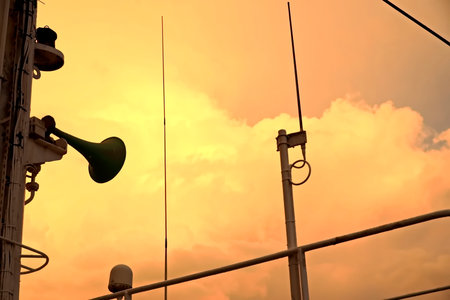 Silhouette of a trumpet on the mast of a ship.
